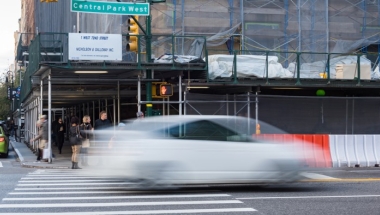 An image of a car speeding down Central Park West.